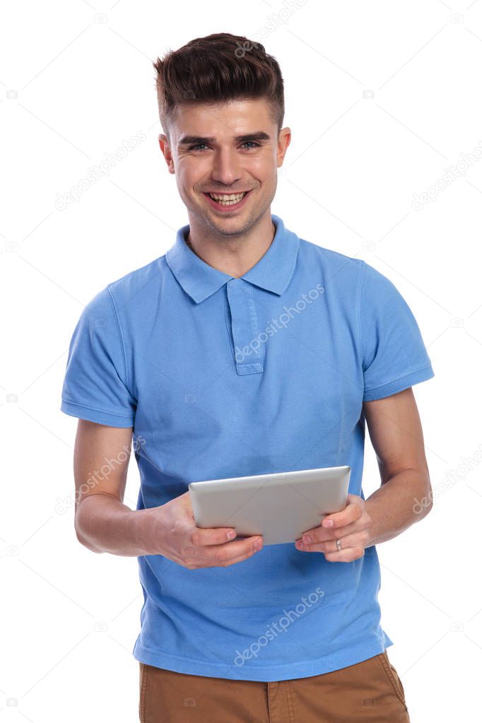 young casual man with a tablet pad computer on white background