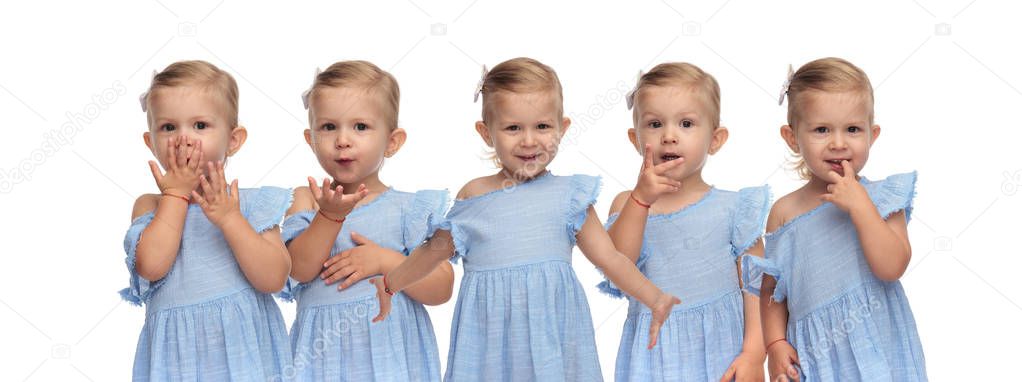 beautiful little girl sends a kiss, welcomes, counts and holds finger in her mouth on white background