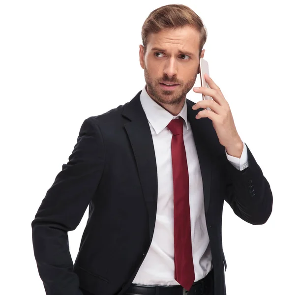 Portrait Worried Businessman Talking Phone Looking Side While Standing White — Stock Photo, Image