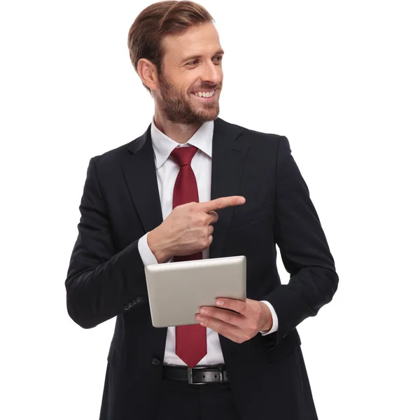 Portret Interesującego Uśmiechniętego Biznesmena Tabletem Patrzącego Stronę Stojącego Białym Tle — Zdjęcie stockowe