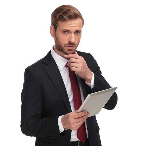 Portrait Pensive Young Businessman Holding His Pad While Standing White — Stock Photo, Image