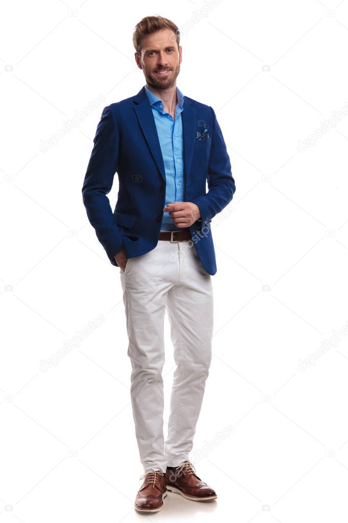 smiling young man in blue suit standing on white background