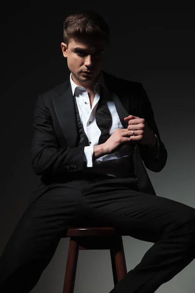 Portrait Handsome Groom Pulling Something Tuxedo Pocket While Sitting Wooden — Stock Photo, Image