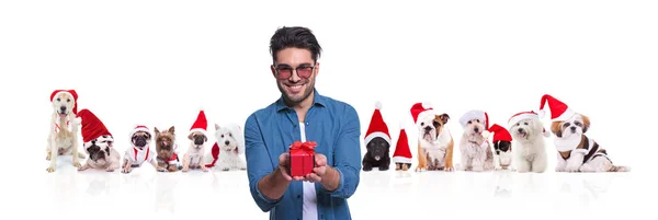 Portrait Young Casual Man Giving Present Smiling Front Large Team — Stock Photo, Image