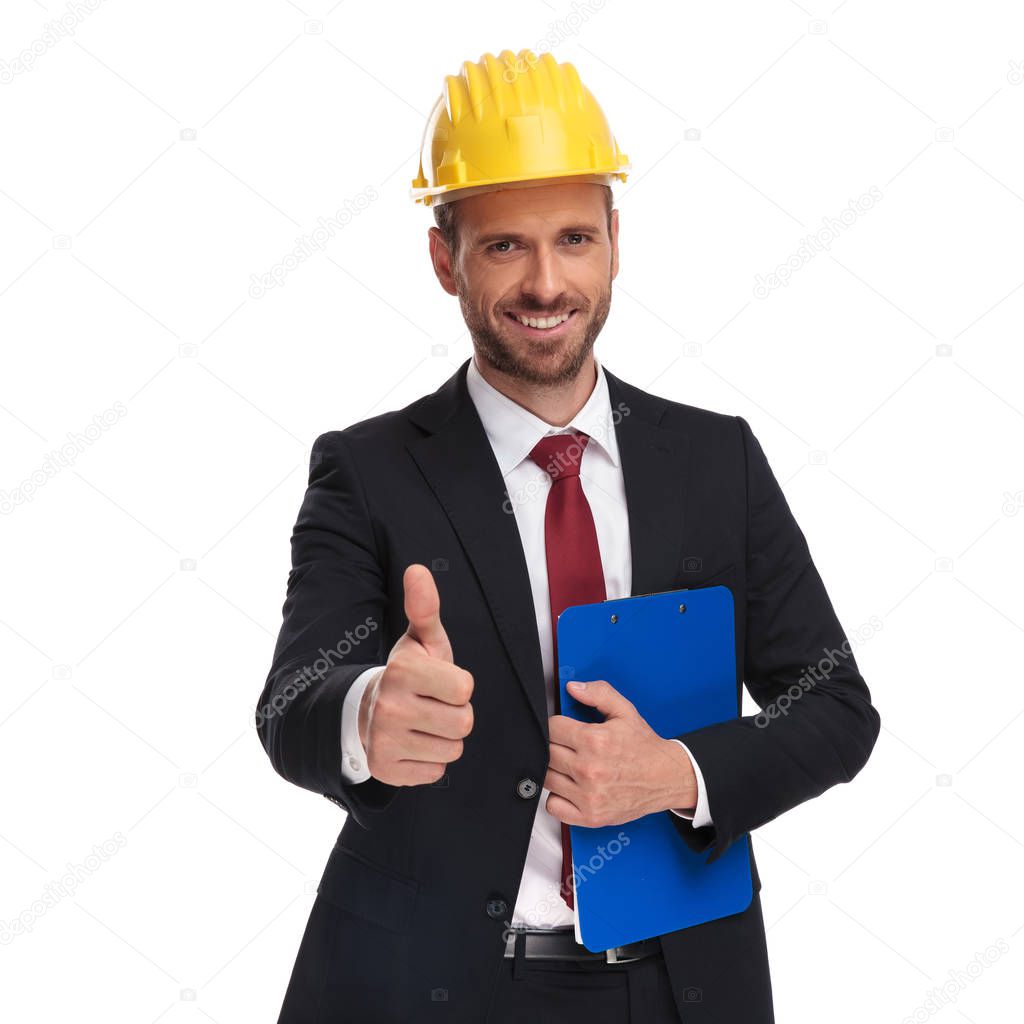 portrait of engineer boss with blue folder making ok sign while standing on white background