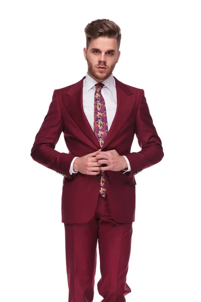 Portrait Seductive Young Man Buttoning His Grena Colored Suit While — Stock Photo, Image