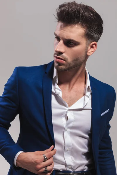 Fashion Man Holding His Coat Collar Looks Side Grey Background — Stock Photo, Image