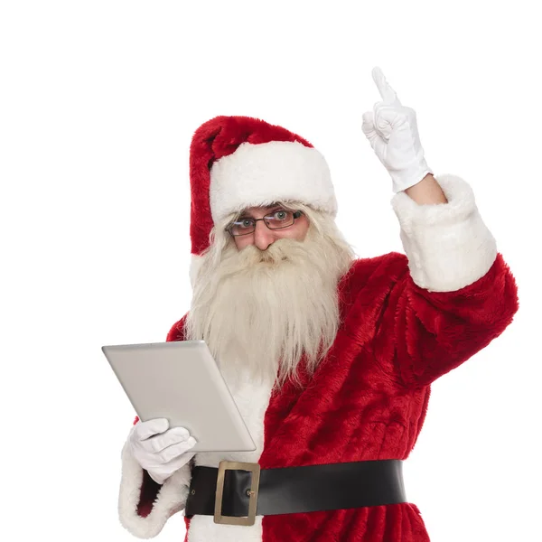 Portrait Santa Claus Holding Tablet Pointing Finger Air While Standing — Stock Photo, Image