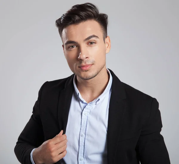 Portrait Young Businessman Holding Black Suit Collar While Standing Light — Stock Photo, Image