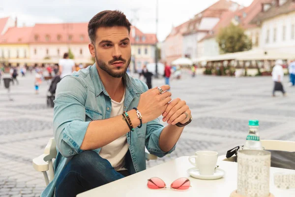 Casual Man Sitting Table City Center Looks Side While Holding — Stock Photo, Image