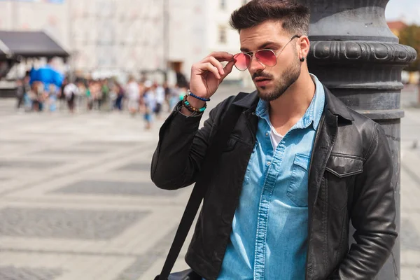 Portrait Curious Casual Man Fixing Red Sunglasses While Standing City — Stock Photo, Image