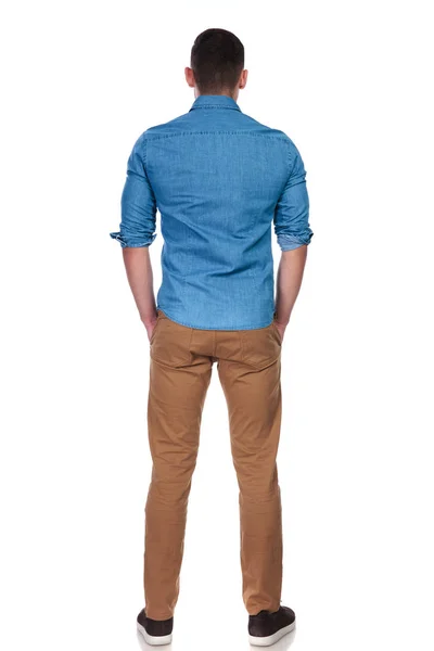 Back View Young Relaxed Casual Man Standing White Background Hands — Φωτογραφία Αρχείου