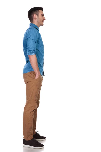 Young Casual Man Waits Line Hands Pockets While Standing White — Stock Photo, Image