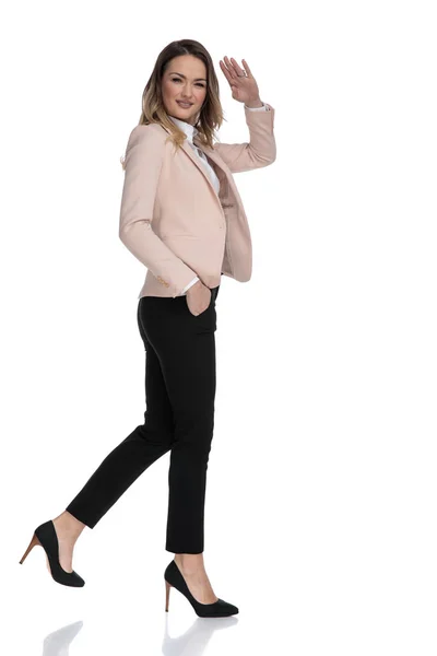 Side View Relaxed Businesswoman Walking White Background Hand Pockets Saluting — Stock Photo, Image