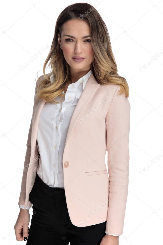 portrait of young blonde businesswoman standing on white background