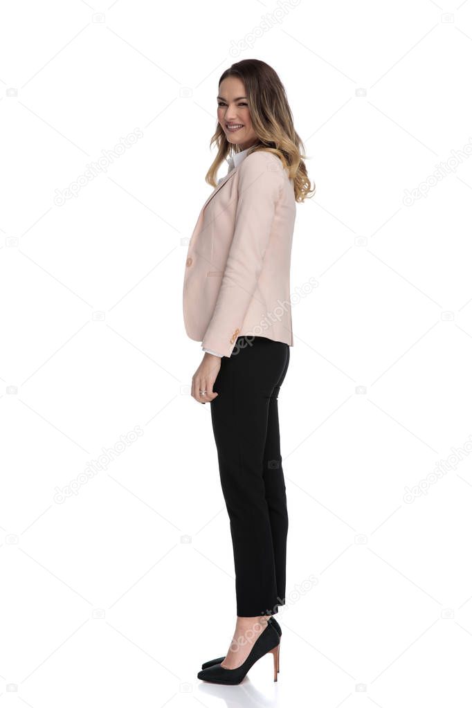 happy businesswoman in pink suit waiting in line while standing on white background, full body picture