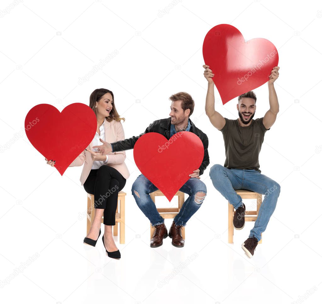 three casual people sharing the love while sitting on white background