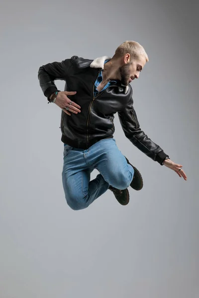 Man Leather Jacket Jeans Jumping High Air Leaning Side Gray — Stock Photo, Image