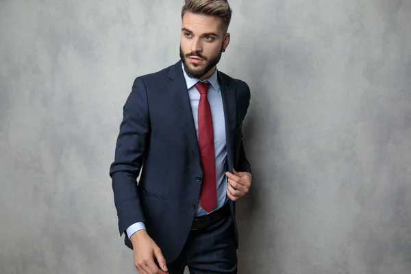 Attractive Young Businessman Fixing Coat While Walking Studio Grey Wall — Stock Photo, Image