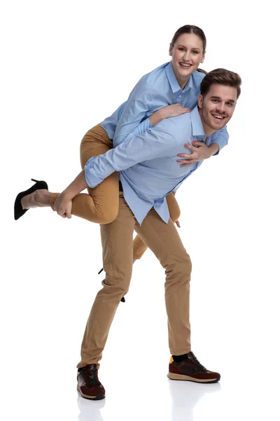 Happy Casual Man Carries Woman His Back White Background — Stock Photo, Image