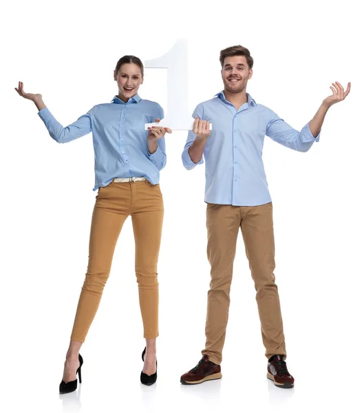 Happy Young Couple Welcome Number One White Background — Stock Photo, Image