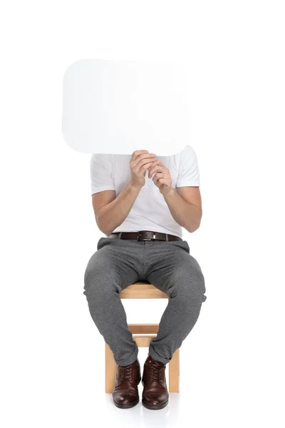 Sentado Hombre Casual Sosteniendo Una Burbuja Del Discurso Sobre Cara — Foto de Stock