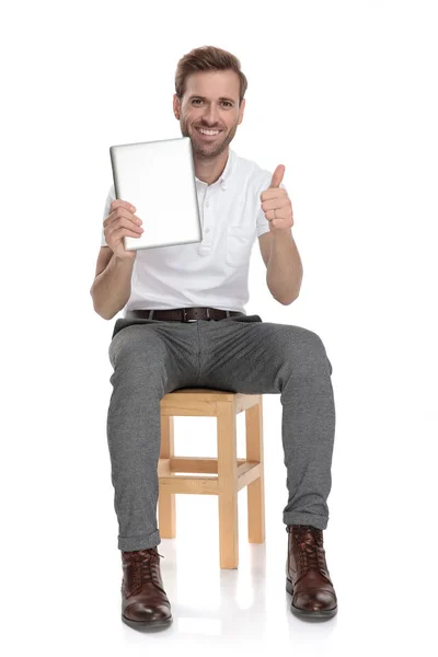 Positive Casual Man Holding Tablet Sitting Chair Makes Sign White — Stock Photo, Image