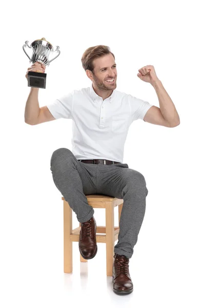 Seated Champion Celebrates His Win Looks Side White Background — Stock Photo, Image