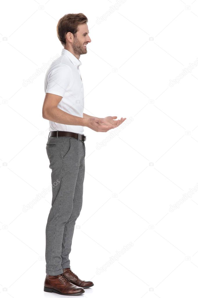 side view of a smiling man explaning something on white background
