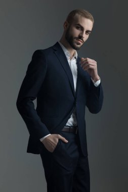 Takım elbiseli sarışın adam cebinde el ile