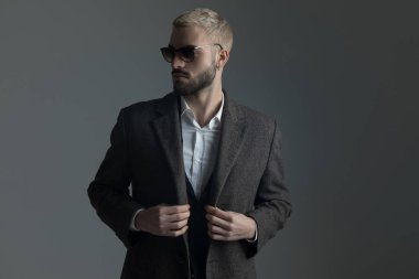 onun longcoat ayarlama güneş gözlüğü ile takım elbiseli sarışın adam