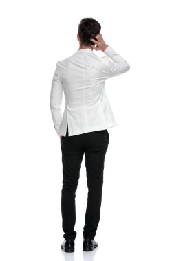 back view of a confused business man scratching his head clipart
