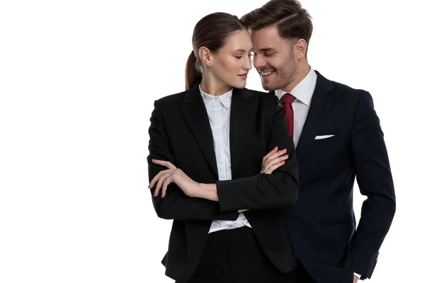 Couple in business suits standing together smiling — Stock Photo, Image