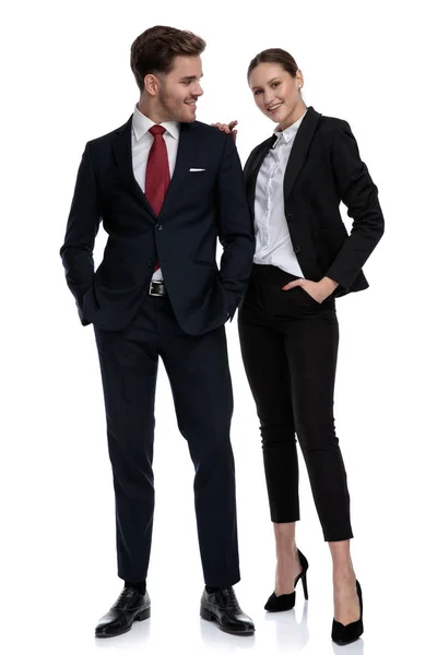 Paar in Business-Anzügen, die Hände in den Taschen — Stockfoto