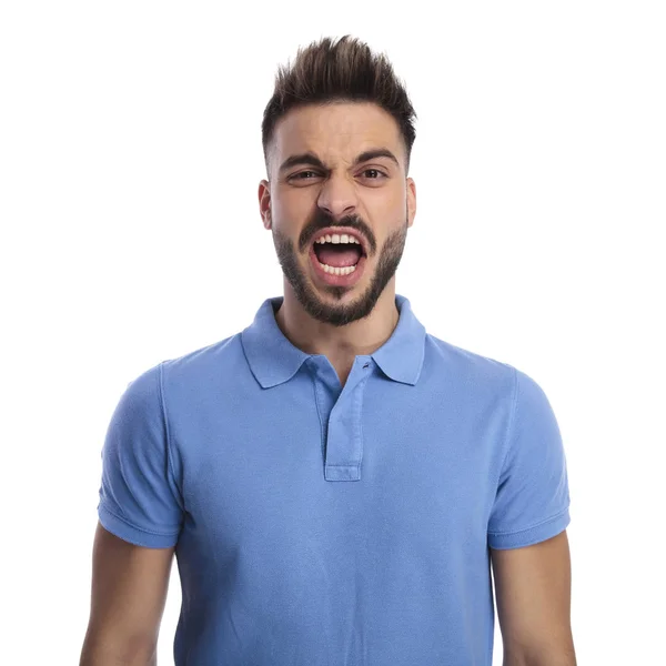 Young man wearing a light blue polo shouting out loud — Stock Photo, Image