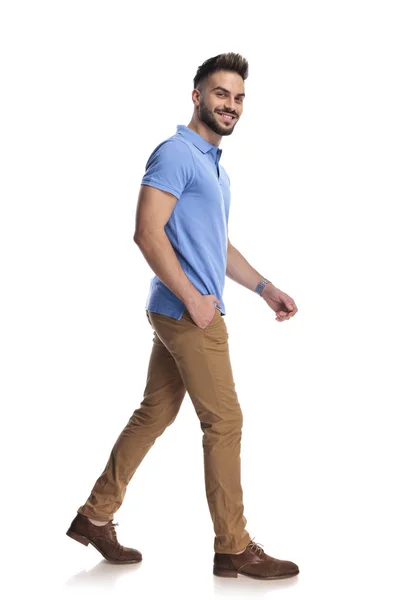 Young attractive man stepping at a side, looking at the camera — Stock Photo, Image