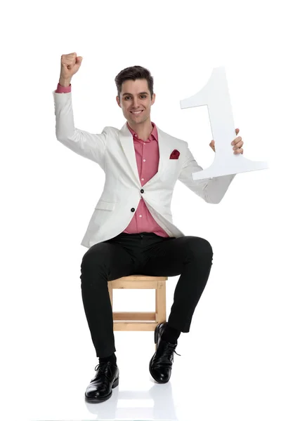 Man celebrating being number on with hands in the air — Stock Photo, Image