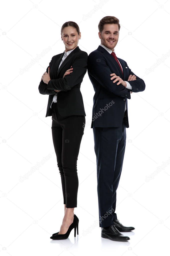 couple in business suits standing back to back