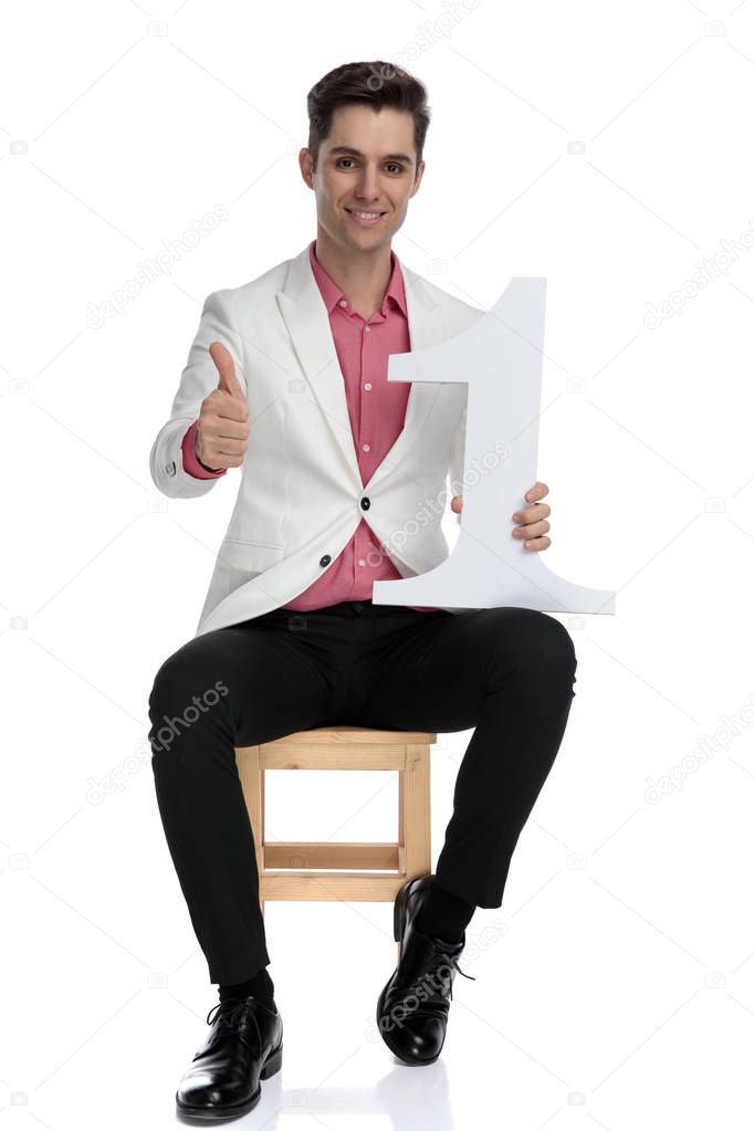 man holding a number one letter makes the ok sign 