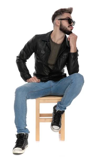 Man thinking while being goofy with tongue out — Stock Photo, Image