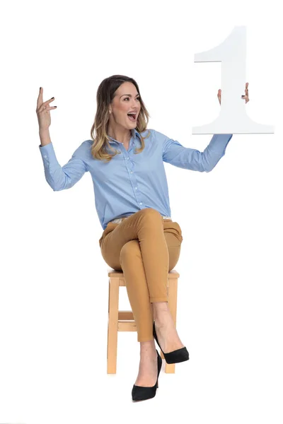 Happy businesswoman holds one and looks to side while celebratin — Stock Photo, Image