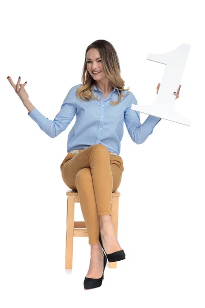 Businesswoman sits on chair and celebrates first place — Stock Photo, Image