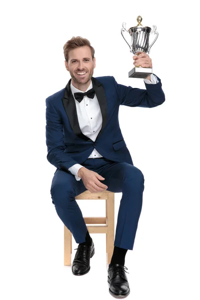 Young man elebrating victory with trophy cup in the air — Stock Photo, Image