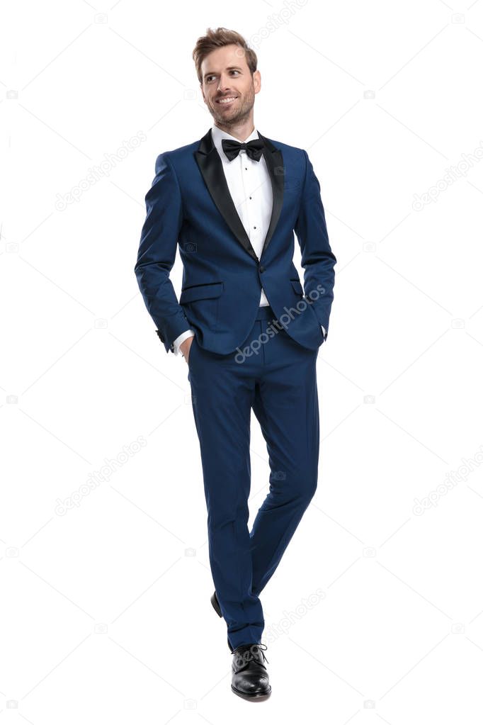 handsome guy in blue costume stepping with hands in pockets