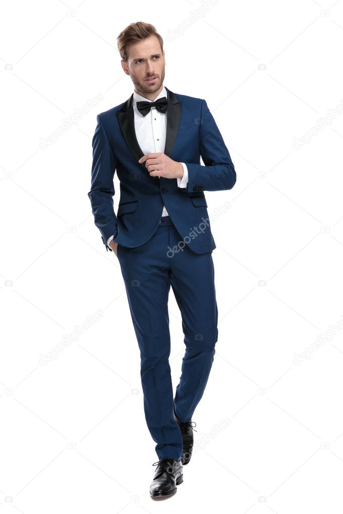 classy man walking with hand in pocket while looking away