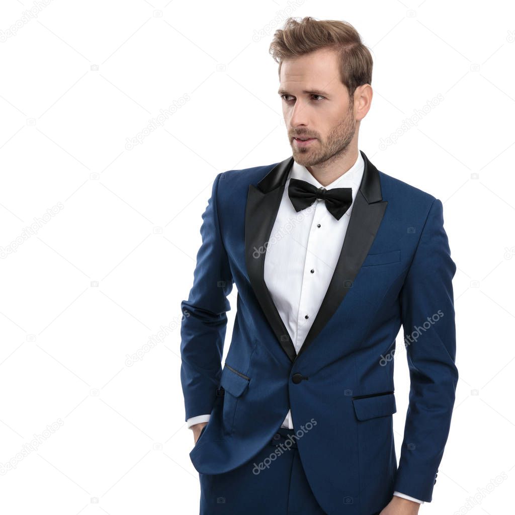 focused man is looking away with hand in pocket