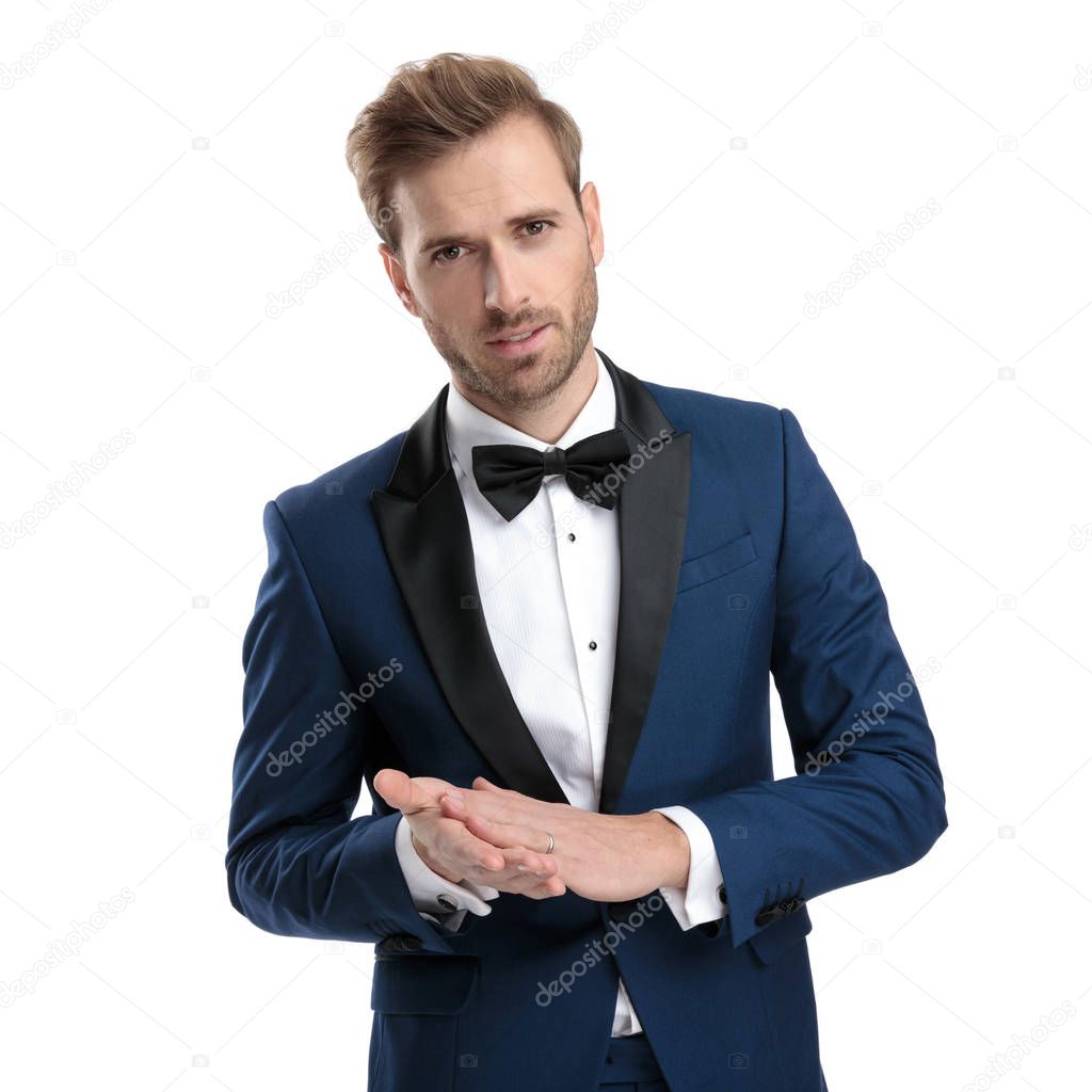 sexy guy in tuxedo rubbing his hands
