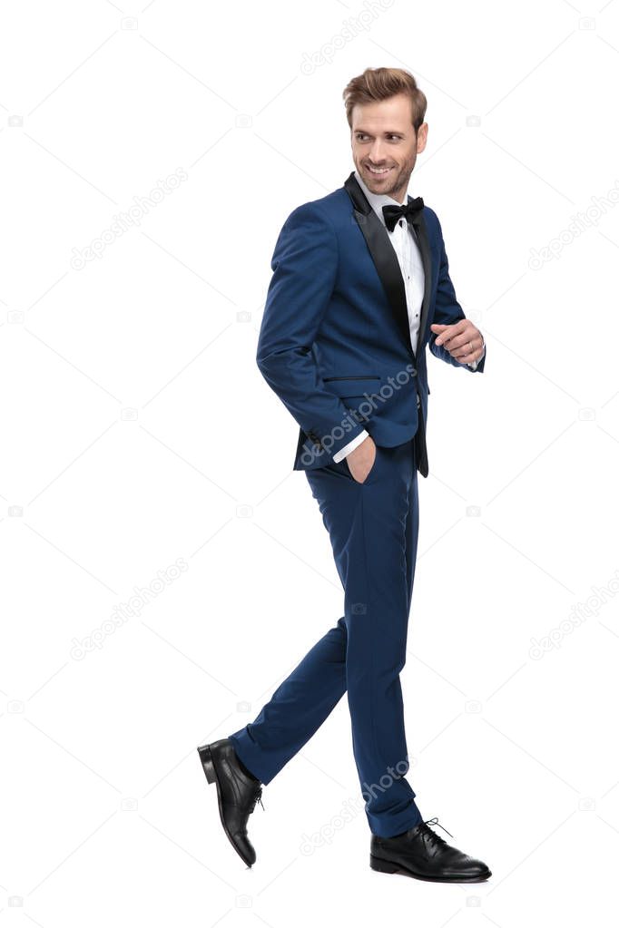 side view of elegant man walking while looking back