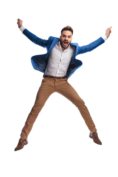 Cool man jumping and screaming with hands in the air — Stock Photo, Image