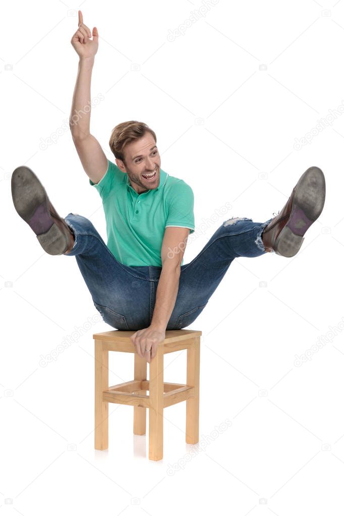 attractive man riding chair like at rodeo being a cowboy